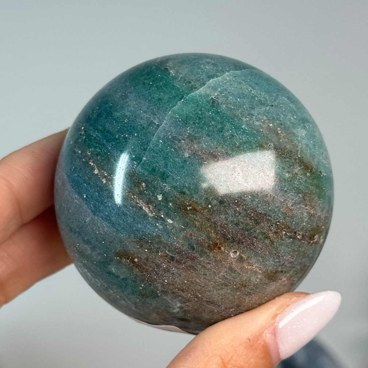 Teal Aventurine Sphere #2, alternate view showing teal-green coloring with brown patches.