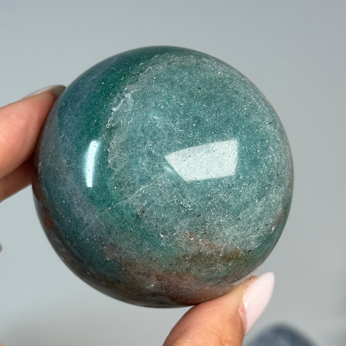 Teal Aventurine Sphere #2, alternate view showing teal-green coloring with brown patches.