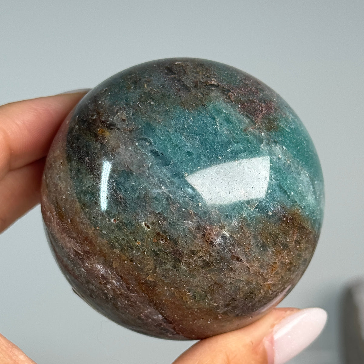Teal Aventurine Sphere #6, alternate view showing teal-green and brown mottled patterns.