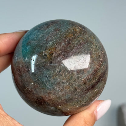 Teal Aventurine Sphere #6, alternate view showing teal-green and brown mottled patterns.