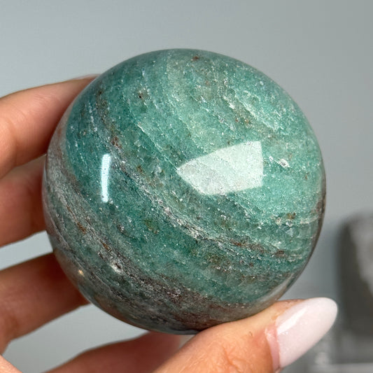 Teal Aventurine Sphere #7, alternate view showing green coloring with fine mottled patterns.