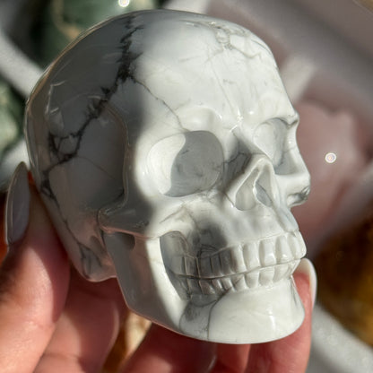 Skull Carving - Howlite #17, front view showing white coloring with gray branching veins.