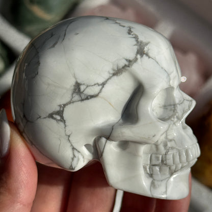 Skull Carving - Howlite #17, side view showing white coloring with gray branching veins.