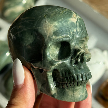 Skull Carving - Green Dragon Jasper #2, front view showing deep green coloring with pale mineral patches.