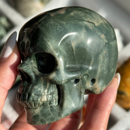 Skull Carving - Green Dragon Jasper #2, opposite side view showing deep green coloring with pale mineral patches.