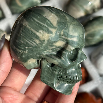 Skull Carving - Green Dragon Jasper #4, opposite side view showing dark green coloring and pale curved bands.