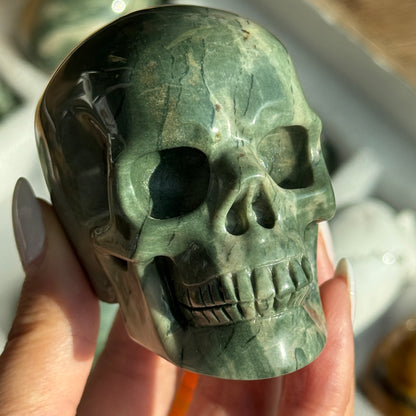 Skull Carving - Green Dragon Jasper #5, front view showing green coloring with cream mineral patches.