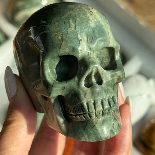 Skull Carving - Green Dragon Jasper #5, front view showing green coloring with cream mineral patches.