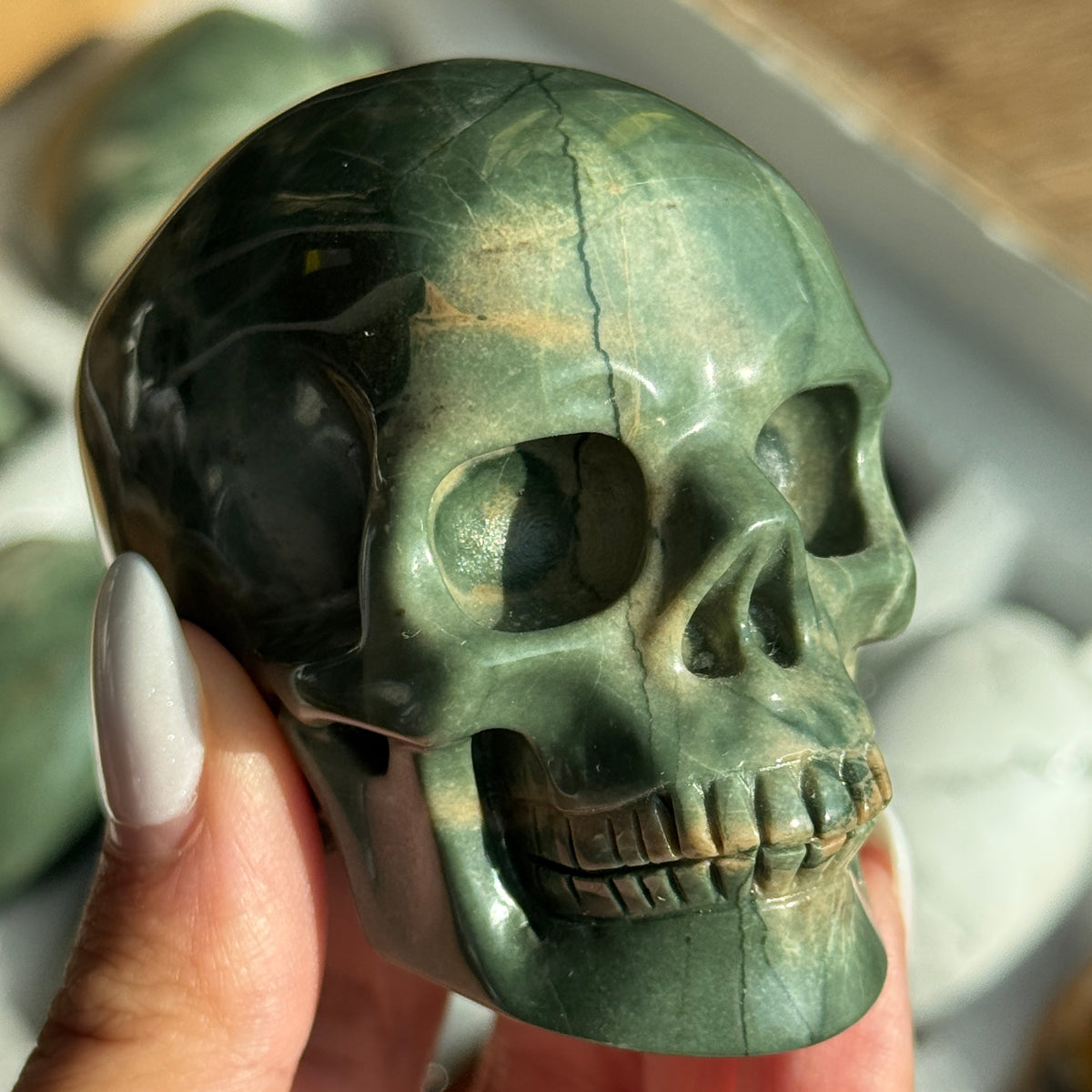 Skull Carving - Green Dragon Jasper #6, front view showing green coloring with cream and tan veining.