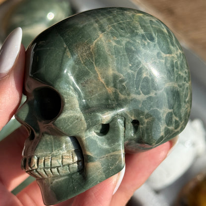 Skull Carving - Green Dragon Jasper #6, opposite side view showing green coloring with cream and tan veining.