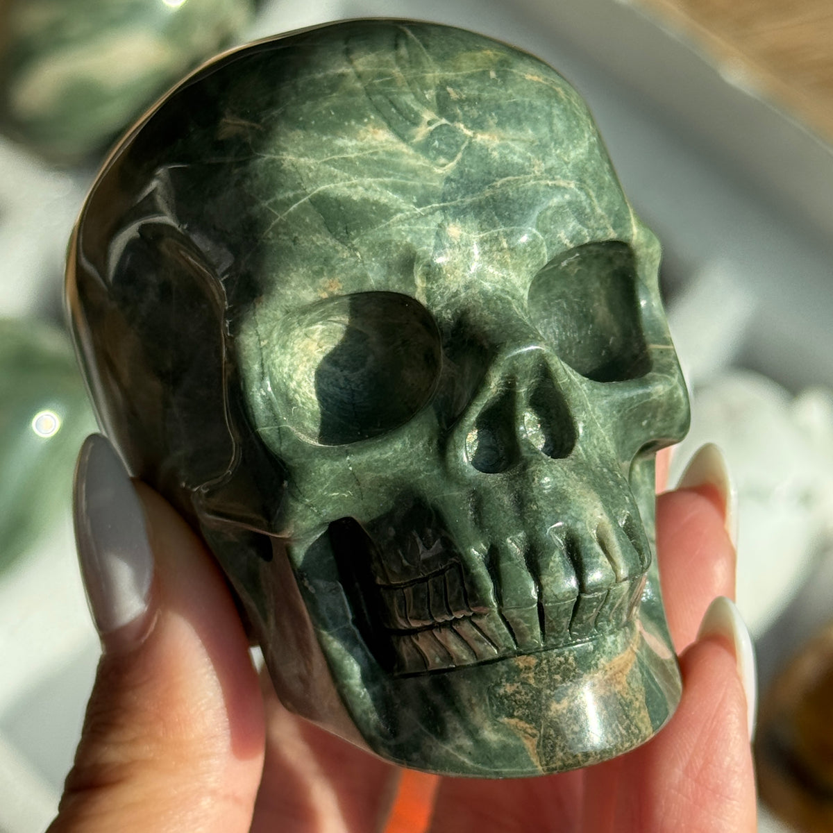 Skull Carving - Green Dragon Jasper #7, front view showing dark green and cream mottled patterns.