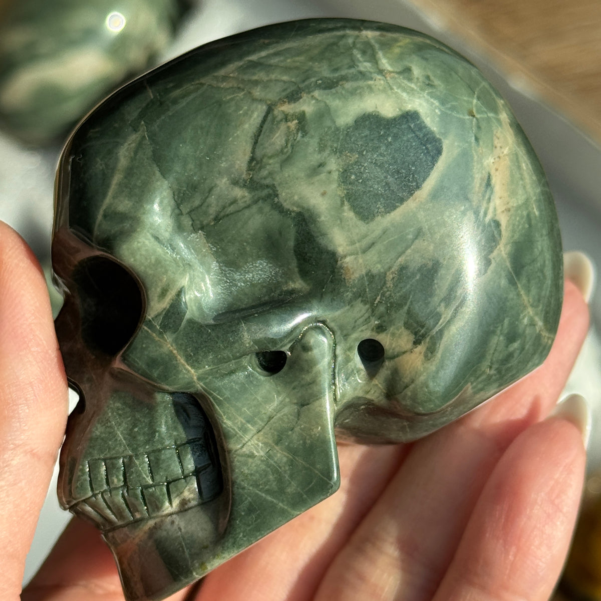 Skull Carving - Green Dragon Jasper #7, opposite side view showing dark green and cream mottled patterns.