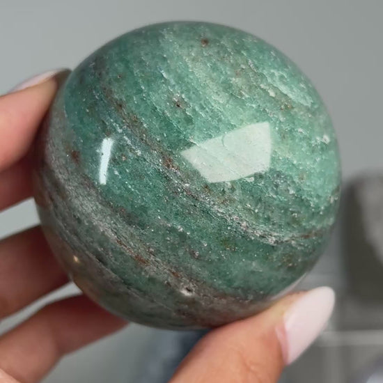 Video of Teal Aventurine Sphere #7, showing green coloring with fine mottled patterns across the polished sphere.