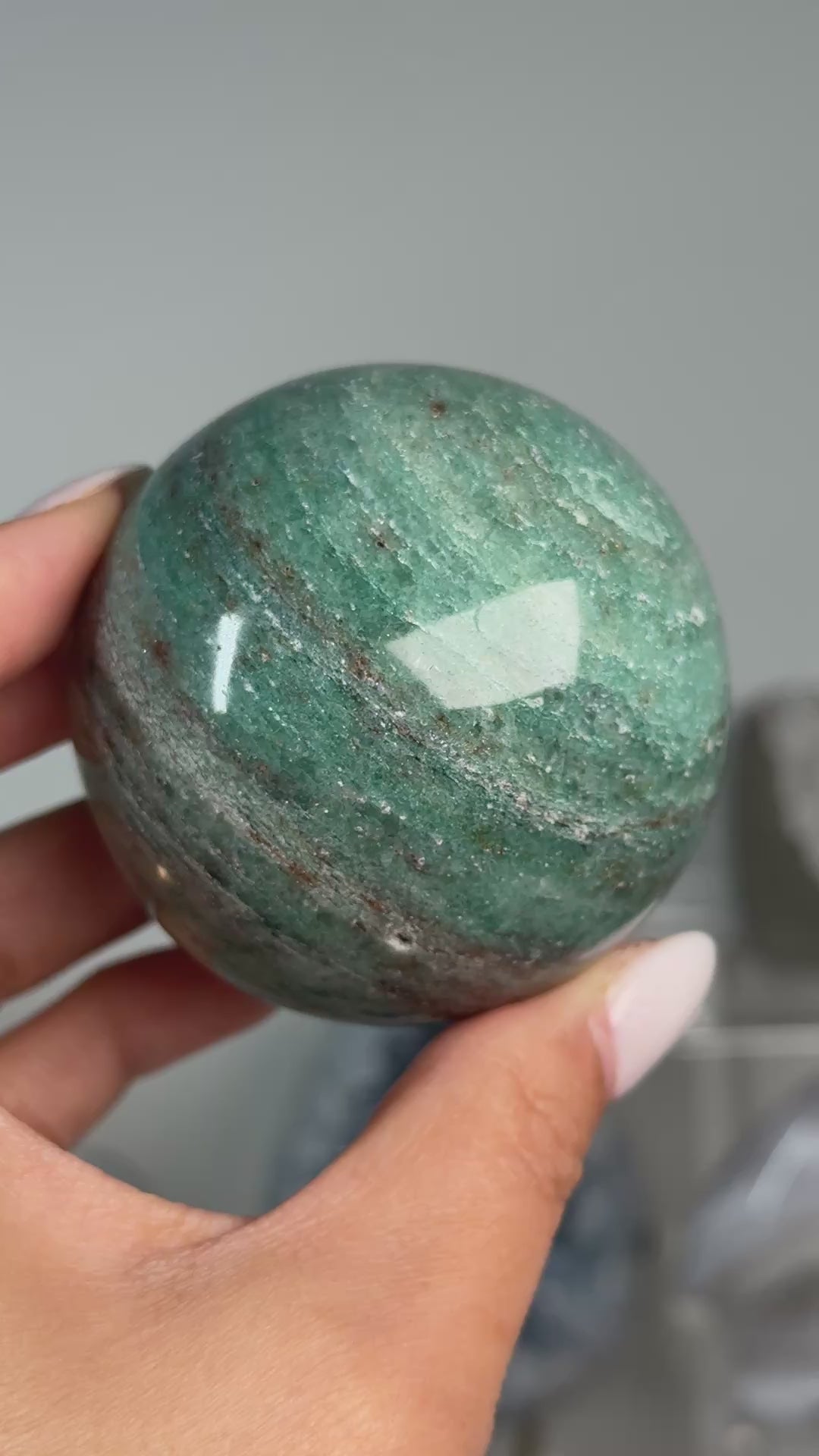 Video of Teal Aventurine Sphere #7, showing green coloring with fine mottled patterns across the polished sphere.