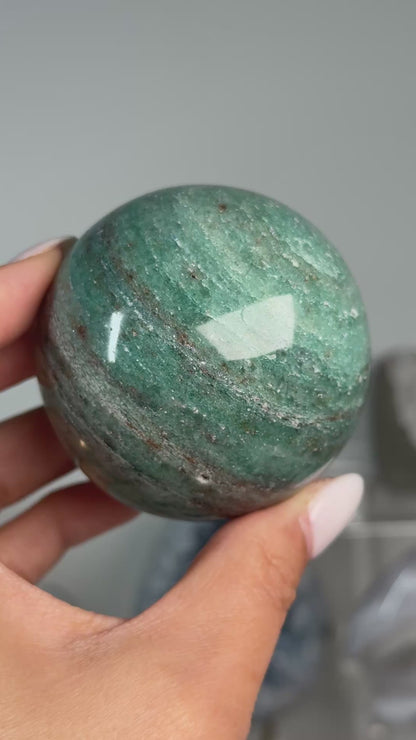 Video of Teal Aventurine Sphere #7, showing green coloring with fine mottled patterns across the polished sphere.