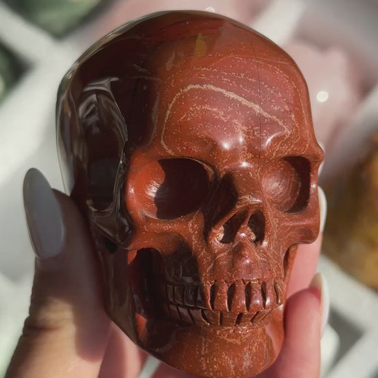 Video of Skull Carving - Red Jasper #14, showing the carved details and rust-red coloring with fine dark veins.