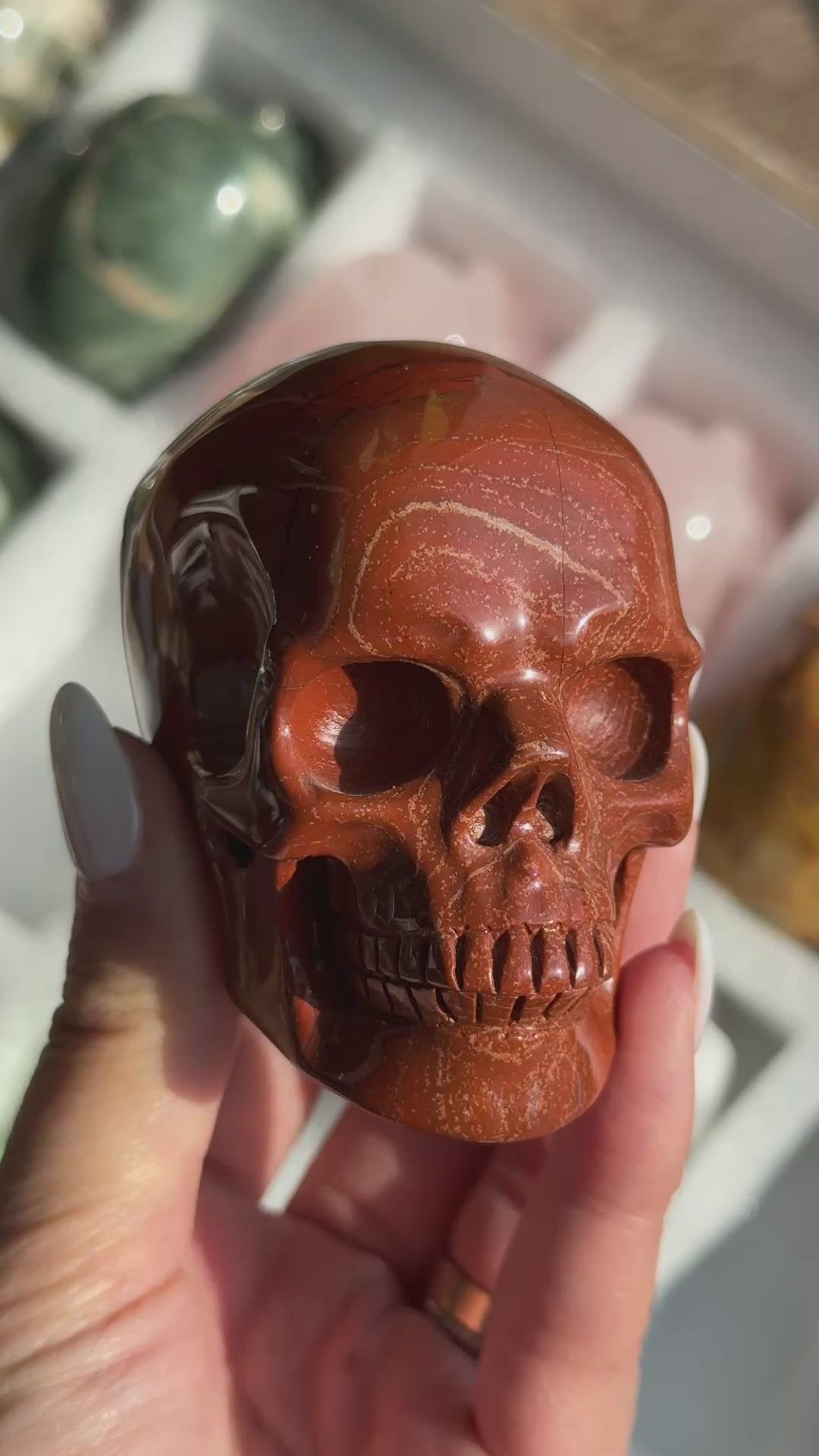 Video of Skull Carving - Red Jasper #14, showing the carved details and rust-red coloring with fine dark veins.