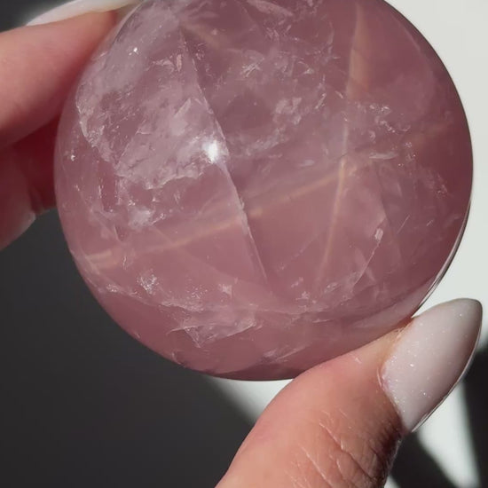 dark pink rose quartz sphere asterism crystals
