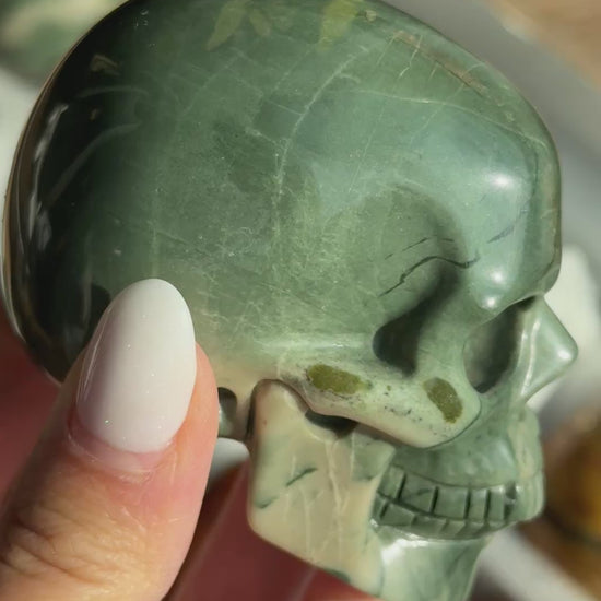 Video of Skull Carving - Green Dragon Jasper #5, showing the carved details and green coloring with cream mineral patches.