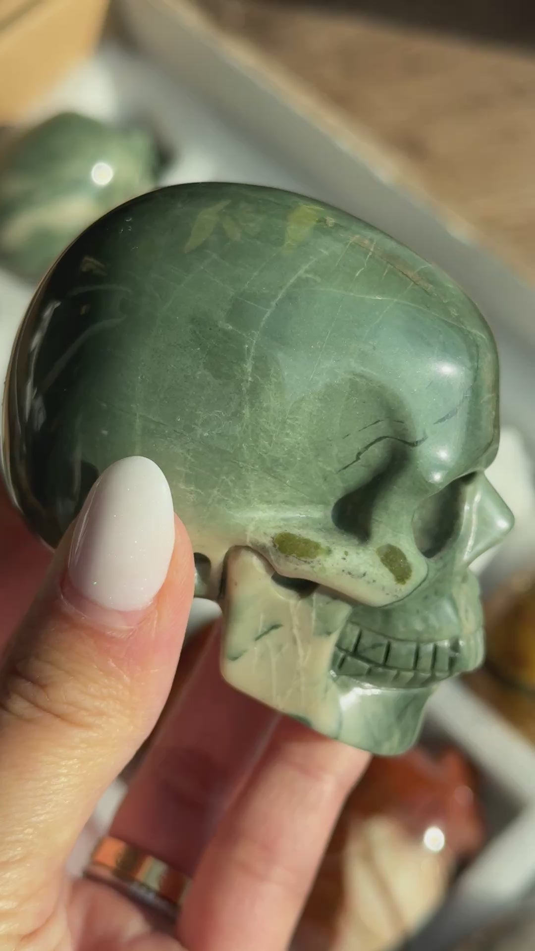 Video of Skull Carving - Green Dragon Jasper #5, showing the carved details and green coloring with cream mineral patches.