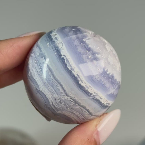 Video of Blue Lace Agate Sphere #2, showing blue and white wavy bands across the polished sphere.