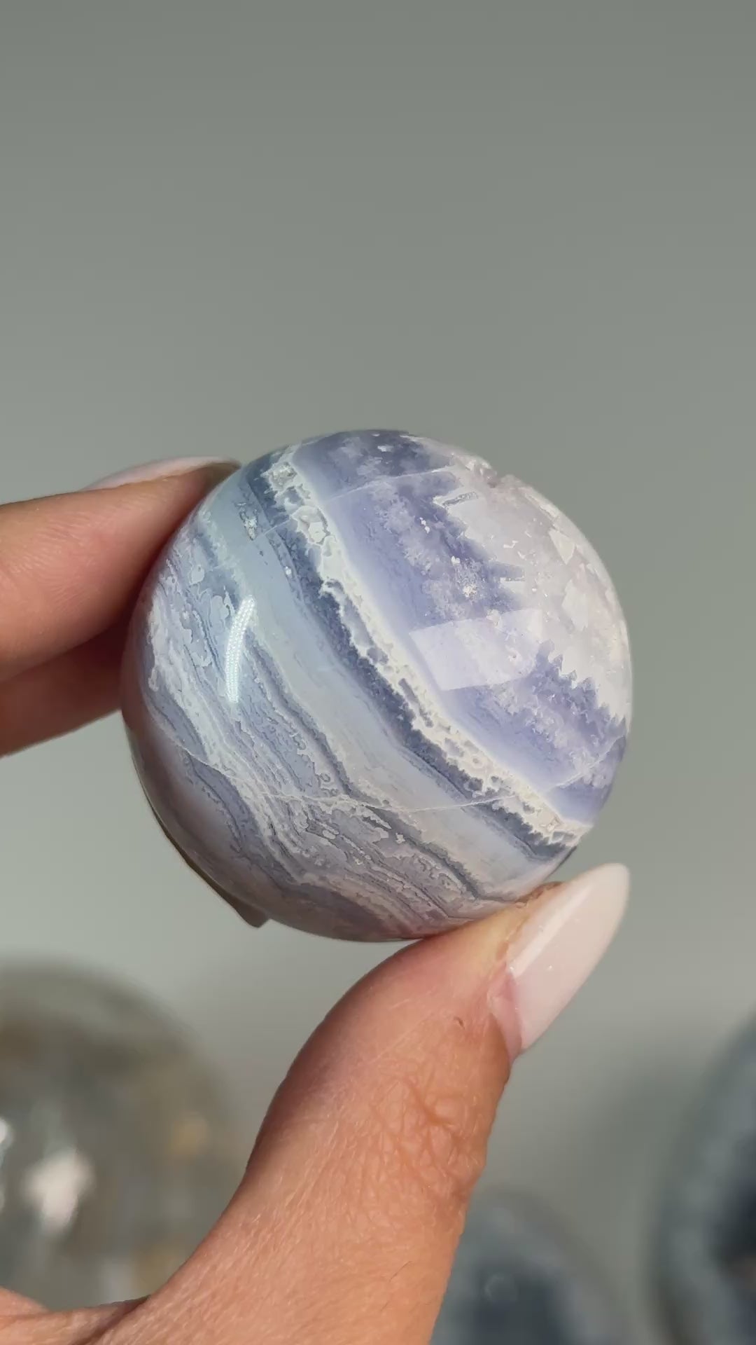 Video of Blue Lace Agate Sphere #2, showing blue and white wavy bands across the polished sphere.