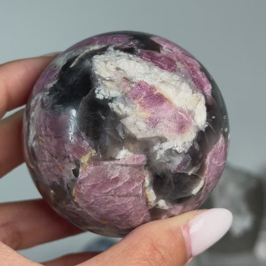 Video of Rubellite (Pink Tourmaline) with Smoky Quartz Sphere #9, showing pink, black and cream mineral patterns across the polished sphere.