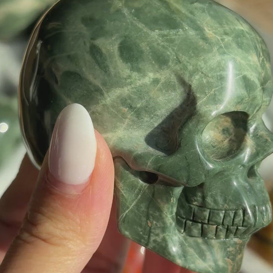Video of Skull Carving - Green Dragon Jasper #7, showing the carved details and dark green and cream mottled patterns.