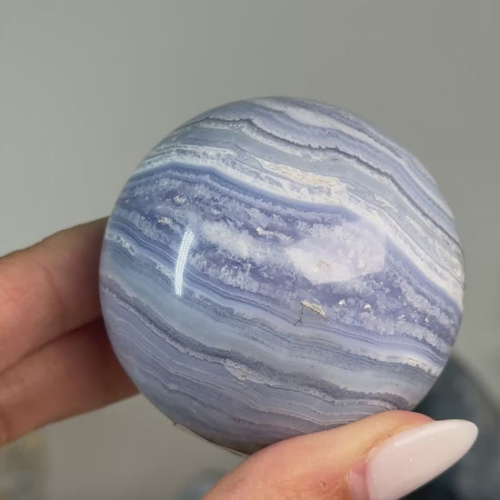 Video of Blue Lace Agate Sphere #4, showing fine blue and white layered bands across the polished sphere.
