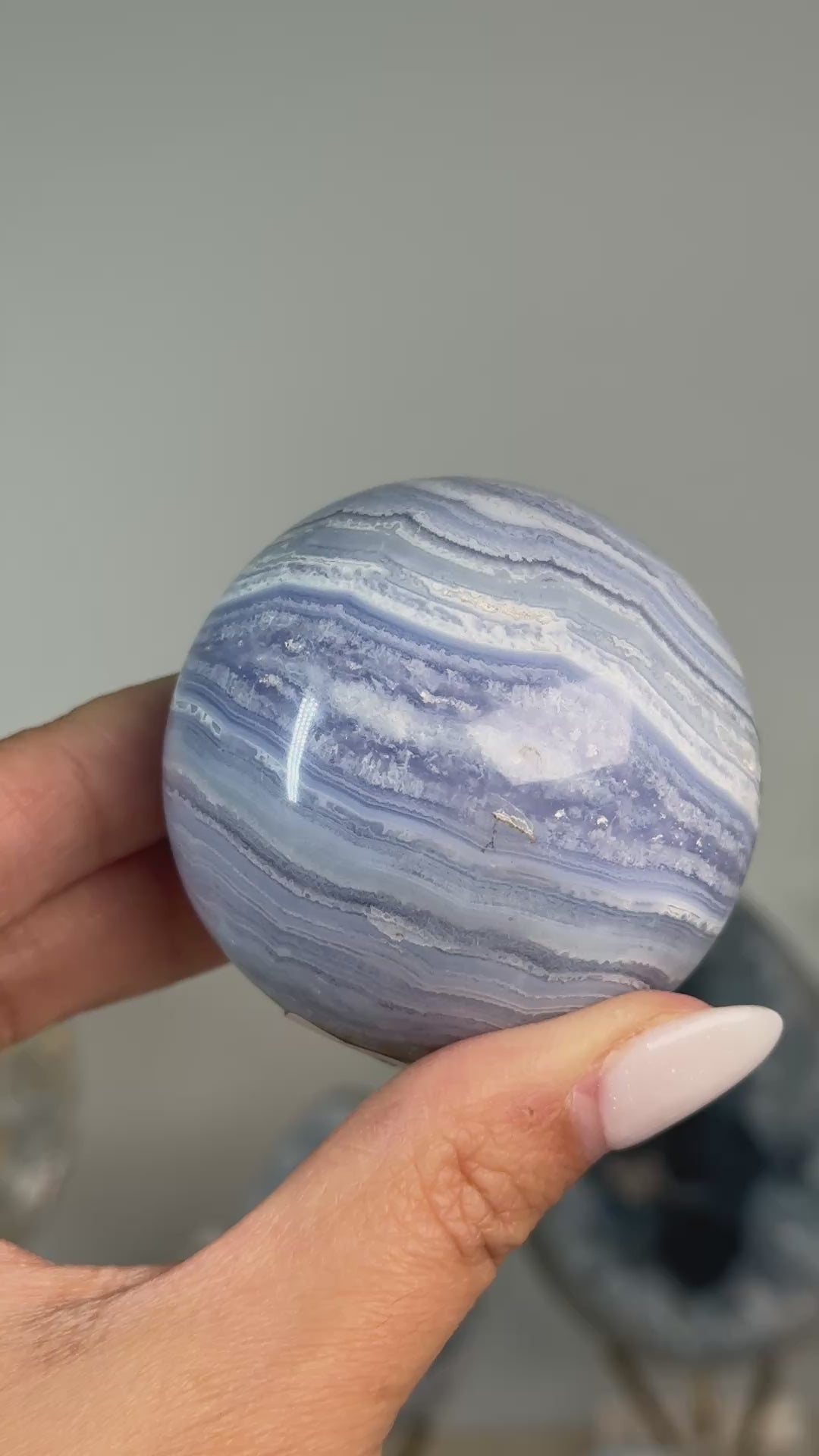 Video of Blue Lace Agate Sphere #4, showing fine blue and white layered bands across the polished sphere.