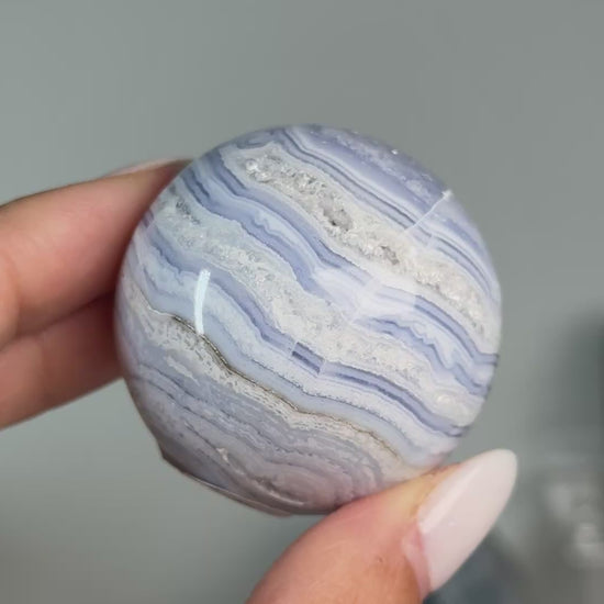 Video of Blue Lace Agate Sphere #8, showing blue and white layered bands across the polished sphere.