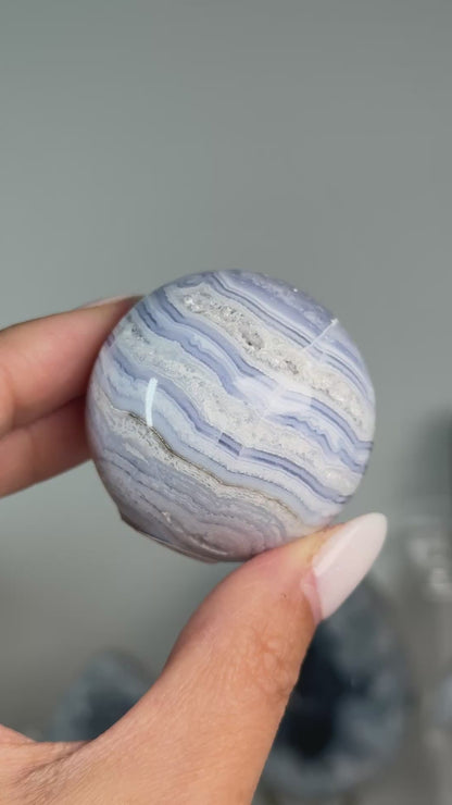 Video of Blue Lace Agate Sphere #8, showing blue and white layered bands across the polished sphere.