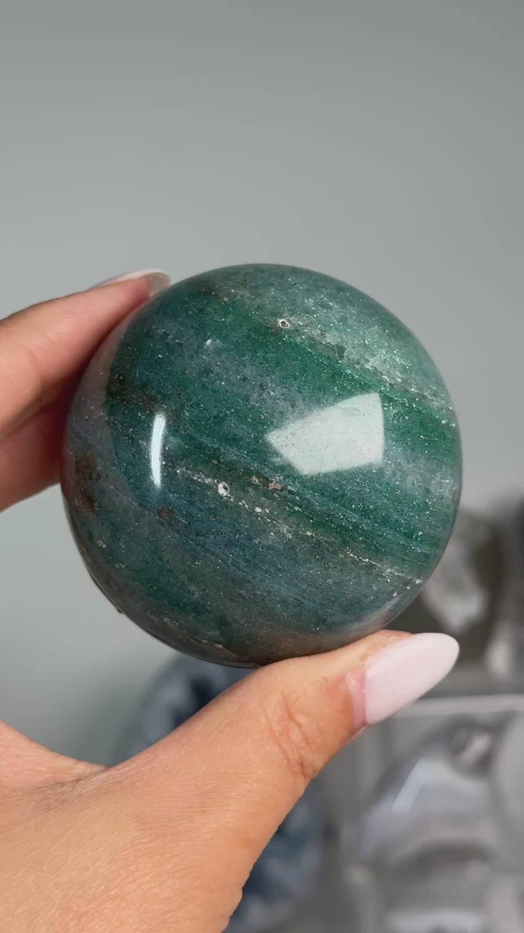 Video of Teal Aventurine Sphere #2, showing teal-green coloring with brown patches across the polished sphere.