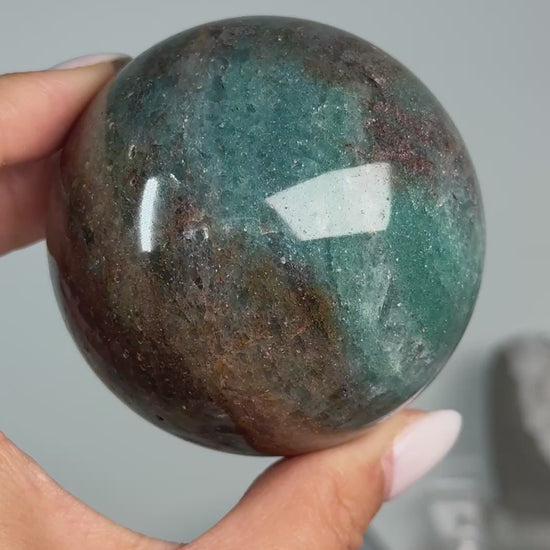 Video of Teal Aventurine Sphere #6, showing teal-green and brown mottled patterns across the polished sphere.