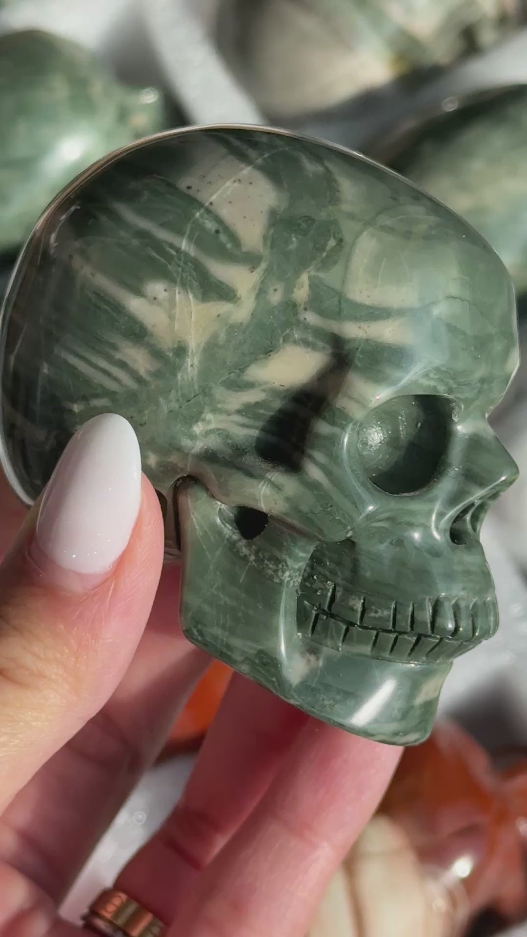 Video of Skull Carving - Green Dragon Jasper #4, showing the carved details and dark green coloring and pale curved bands.