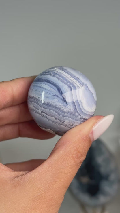 Video of Blue Lace Agate Sphere #12, showing blue and white banding with a brown mineral seam across the polished sphere.