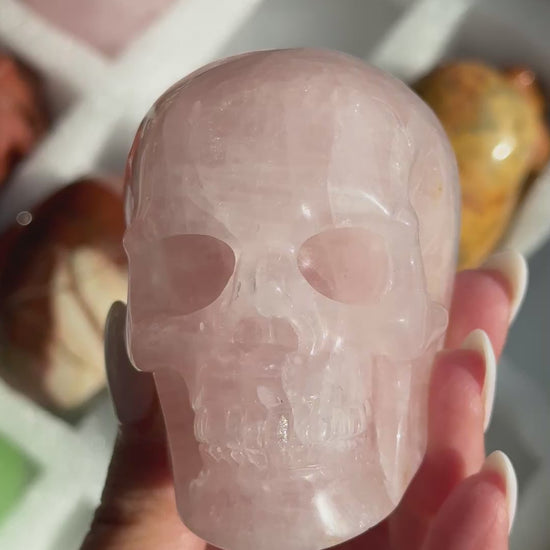 Video of Skull Carving - Rose Quartz #11, showing the carved details and pale pink coloring with cloudy white areas.