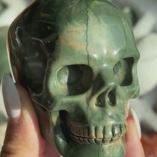 Video of Skull Carving - Green Dragon Jasper #6, showing the carved details and green coloring with cream and tan veining.
