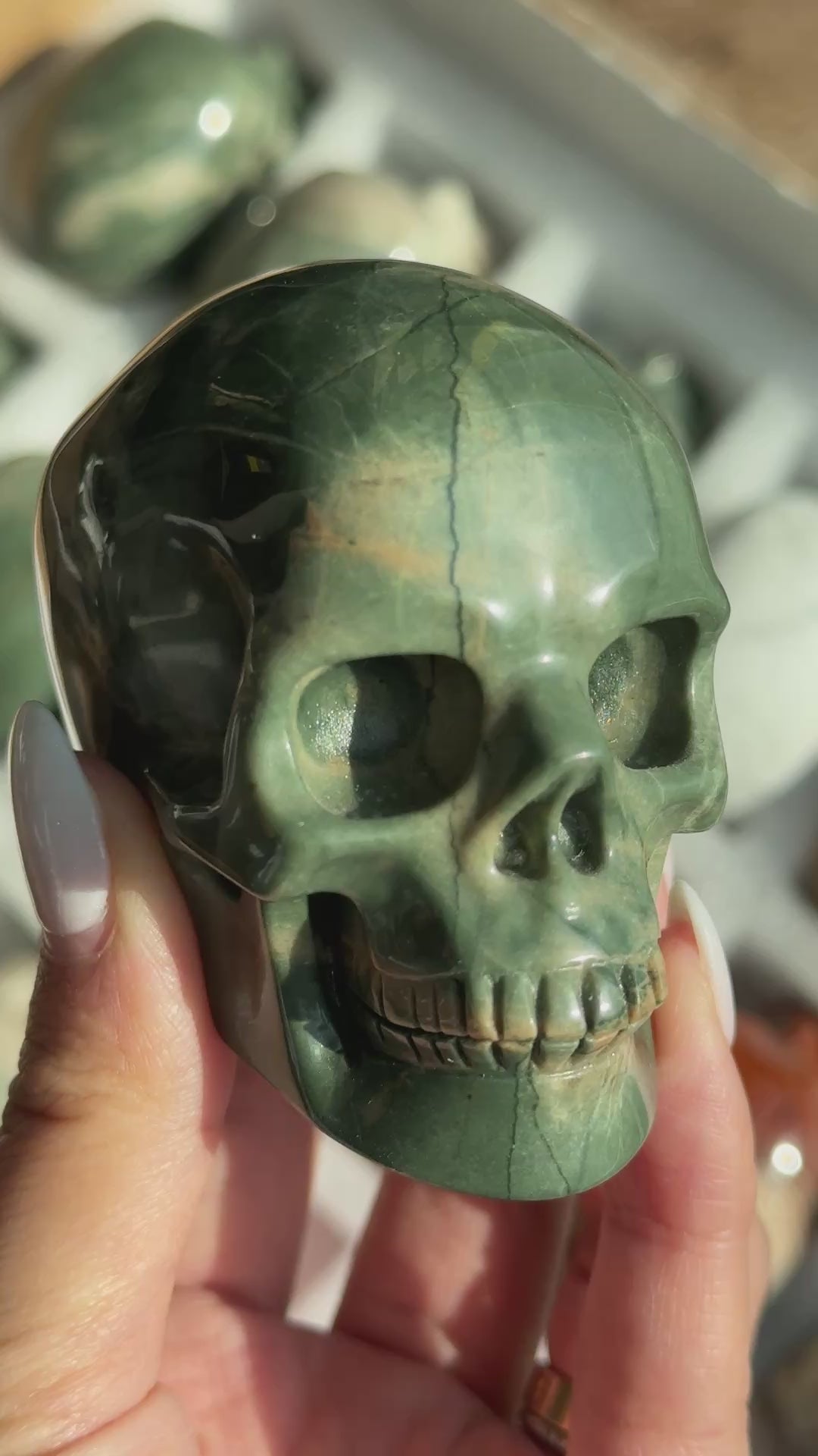 Video of Skull Carving - Green Dragon Jasper #6, showing the carved details and green coloring with cream and tan veining.
