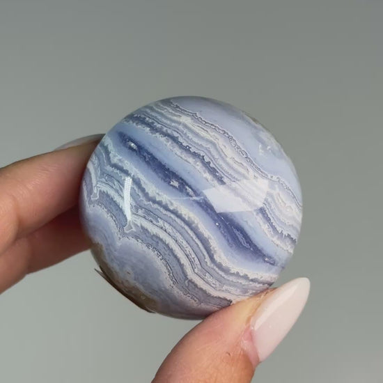 Video of Blue Lace Agate Sphere #1, showing blue and white wavy bands across the polished sphere.