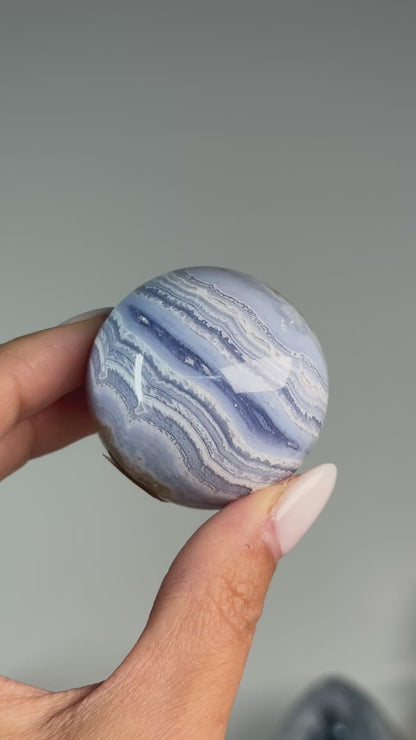 Video of Blue Lace Agate Sphere #1, showing blue and white wavy bands across the polished sphere.