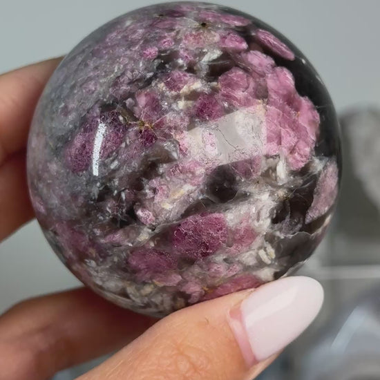 Video of Rubellite (Pink Tourmaline) with Smoky Quartz Sphere #12, showing pink, black and cream mineral patterns across the polished sphere.